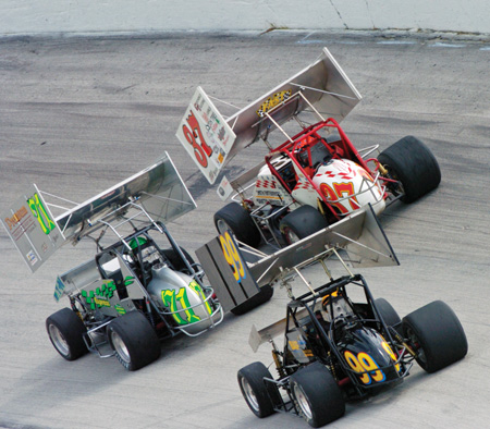 Here, 410 Winged Sprinters battle on pavement. In the large photo at the top, a 410 non-winged sprinter races on dirt.