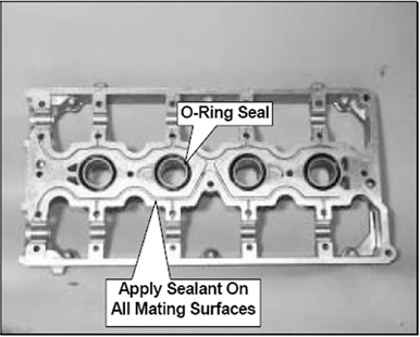 Figure 2 The cam carrier requires an oil tight seal between it and the cylinder head. This is accomplished with four special O-ring seals around the spark plug cavities, and by using a sealant on the mating surfaces.