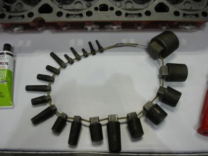 This series shows tapered plugs used to fill cracks in a cylinder head. Tapered plugs are installed, cut off, peened, then finished. At the bottom, a  selection of different plug sizes is seen.