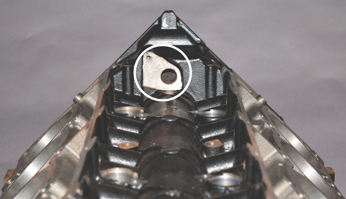 The oil control valve that directs the oil to the phaser through the front cam journal is bolted to a machined pad on the back of the timing cover.