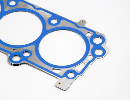 the polymer coating is blue and silk-screened to coat just the areas requiring fluid seal help. the elastomer is expensive and cost savings are achieved by using it just where it is needed.