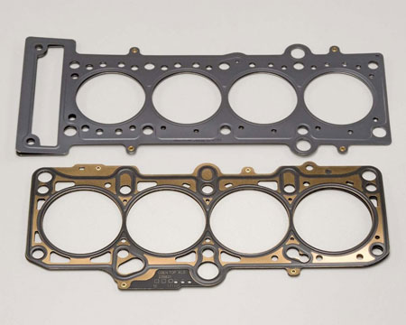 The upper gasket has a full polymer coating, the lower is silk-screened. Both seal fine. The upper was for the aftermarket, so polymer coverage was added for extra protection