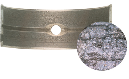 babbitt bearing embedded with machining debris. the inset photo shows microscopic detail of the debris. federal-mogul photo.