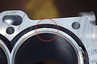 Figure 2 The aluminum 4.6L Cadillac block may crack outside the cast iron cylinder liner and is extremely hard to detect.  The above crack became visible only after the deck face was machined.