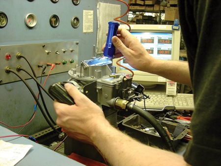 Recarbo insists that used carburetors typically have life left in them and, if rebuilt and set-up correctly, can provide reliable service for a long time. In the background of the photo above, you can see the computer screen full of information that the technician is watching throughout the test. Because of this setup, Recarbo is actually able to guarantee that the carb will pass smog if necessary. 