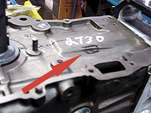 figure 1 ka24 nissan sohc block may have timing chain wear that looks like a machined surface. the black square area is a hole into the coolant passage.