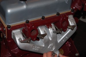 The exhaust manifold is held on as shown in photo and this arrangement works really well for getting a good tight seal against the gasket and block.