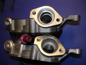 Aftermarket performance oil pumps feature various modifications to improve flow and priming. The performance pump in this photo has a much larger inlet port, and a special add-on port to help self-prime the pump (courtesy of Schumann).