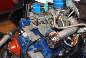 The two four-barrel carbs are jetted for racing and the third carb in the center is used for the idling circuit only.